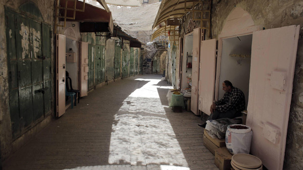 A Palestinian shop owner waits for customers Reuters
